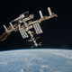 The Space Station orbits earth with a shuttle docked